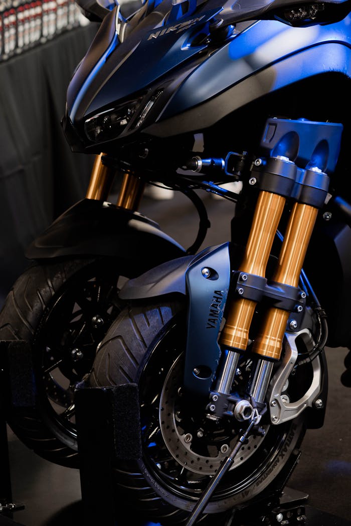 Detailed view of a motorcycle's front suspension showcasing modern design elements and technology.
